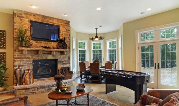 Buckingham lower-level family room with stone fireplace