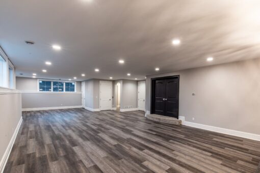 Kingfogl custom home open lower-level recreation space with vinyl plank flooring
