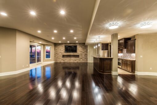Presidio lower-level room with fireplace and dark floors