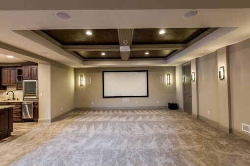 Kingfogl custom home lower-level media room with coffered ceiling and kitchenette