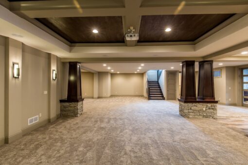 Kingfogl custom home lower level with coffered ceiling and stone-base columns