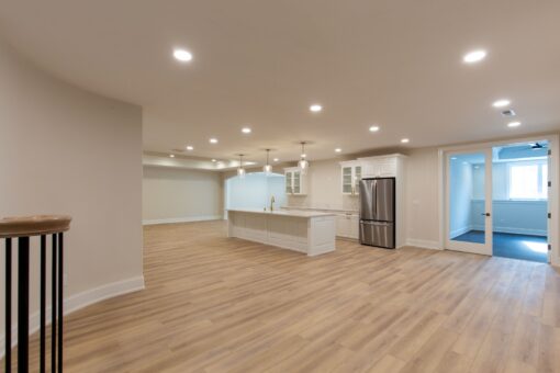 Kingfogl custom home lower level with kitchen island and walk-out doors