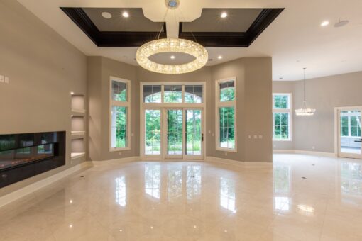 Shire lower-level room with ring chandelier and French doors
