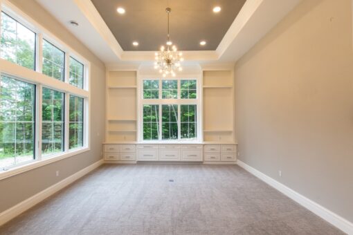 Shire lower-level room with built-in shelving