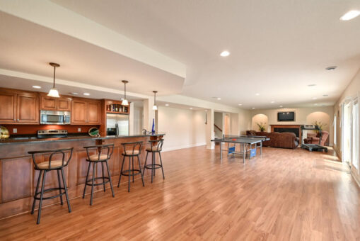 Benington lower-level bar with cherry cabinetry