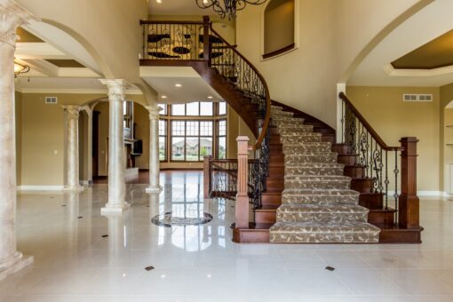 Richland foyer curved staircase with wrought-iron railing