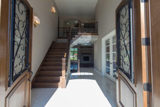 Auburn foyer through iron entry doors with staircase