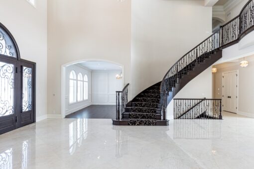 Prescott foyer curved staircase with wrought-iron railing