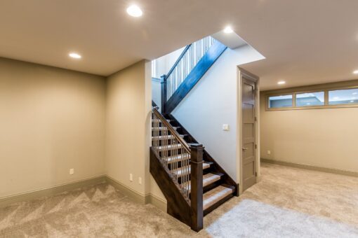 Compton lower-level staircase with wood railing