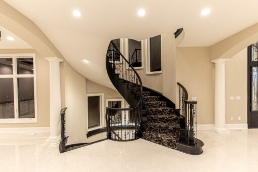 Saddlebrook spiral staircase with iron railing in the foyer