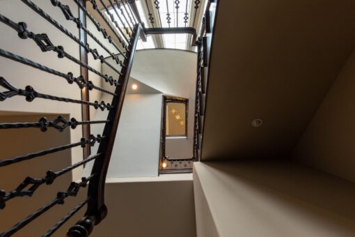 Kingfogl custom home iron stair balusters viewed from below