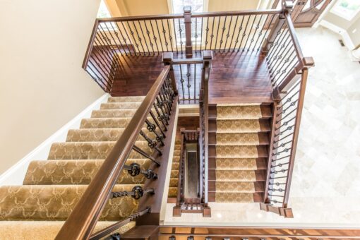 Kingfogl custom home switchback staircase with carpet runner viewed from above