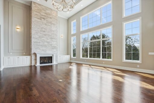 Rangeline great room with stone fireplace and window wall