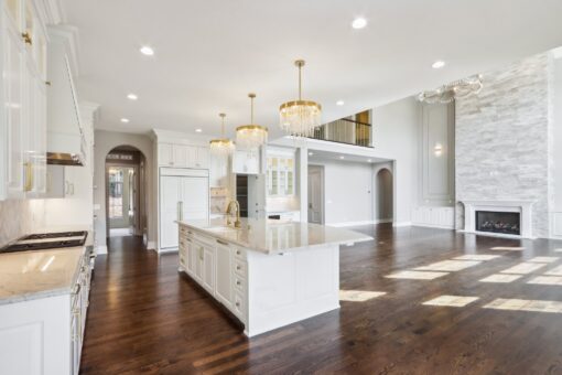 Rangeline kitchen with white island and chandeliers
