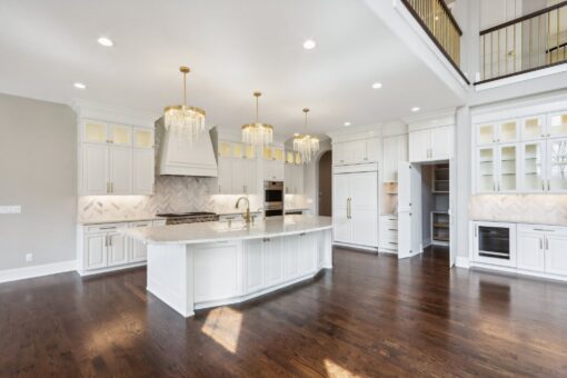 Rangeline white kitchen with island and balcony above