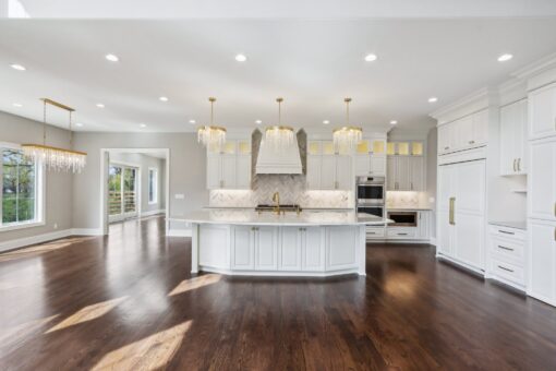 Rangeline white kitchen with island and crystal chandeliers