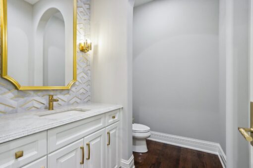 Rangeline bathroom with brass mirror and patterned backsplash