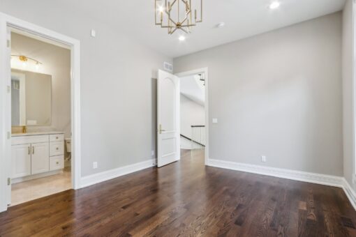 Rangeline bedroom with hardwood floors and chandelier