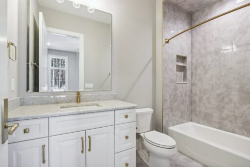 Rangeline bathroom with white vanity and tub