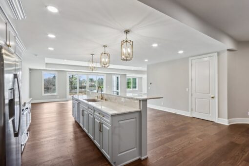 Rangeline lower-level kitchen with gray island and pendants