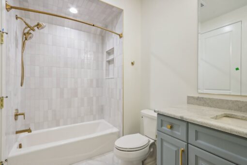 Rangeline bathroom with tub and gray vanity