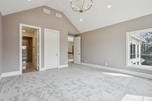 Rangeline bedroom with vaulted ceiling and chandelier