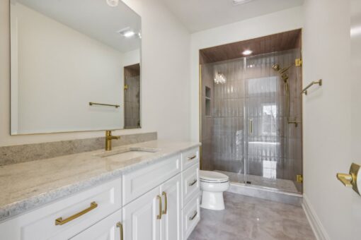 Rangeline bathroom with white vanity and tile shower