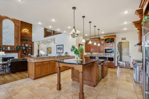 Danbury kitchen island with chandeliers and breakfast area