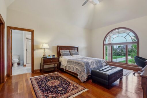Danbury bedroom with arched window and vaulted ceiling
