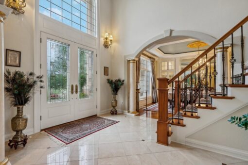 Danbury foyer with French doors and curved staircase
