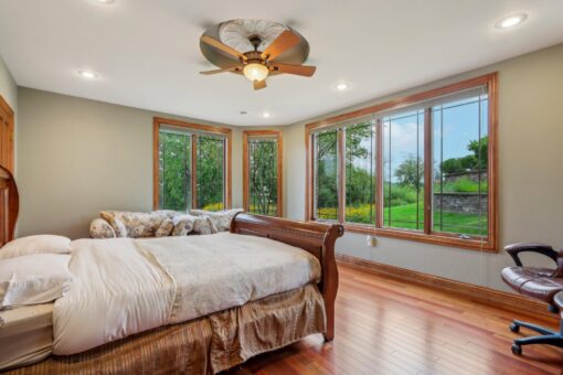 Danbury bedroom with window wall and ceiling fan