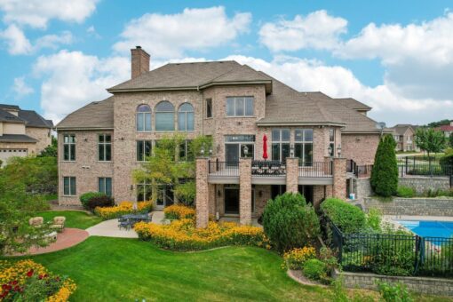 Danbury custom home by Kingfogl, rear elevation with brick exterior and landscaped gardens