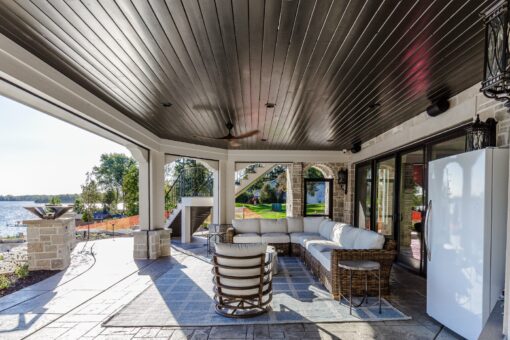 Gatsby covered lower-level patio with outdoor lounge overlooking the lake