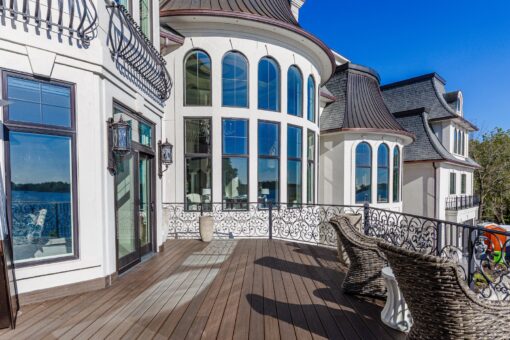 Gatsby lakeside deck beside the curved window walls and turret