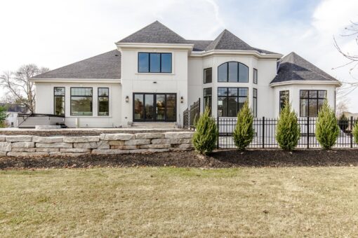 Settlers Circle front elevation with white exterior and iron fence