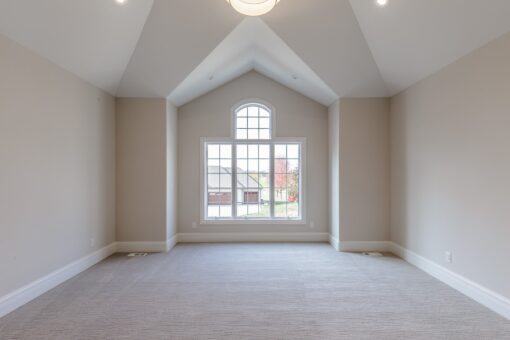 Settlers Circle bedroom with arched window and vaulted ceiling