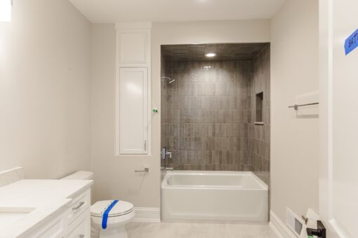 Settlers Circle bathroom with tub and dark tile surround