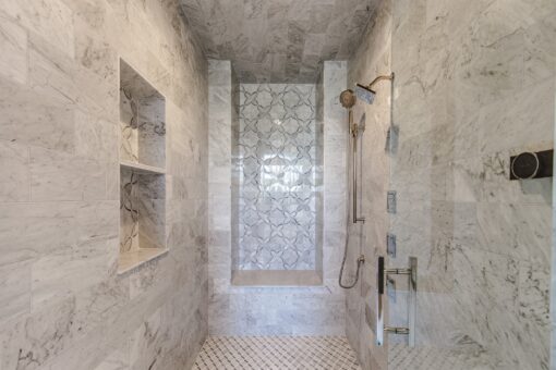 Settlers Circle walk-in marble shower with mosaic panel and niches