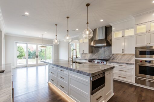Settlers Circle kitchen island with marble top and pendant lights