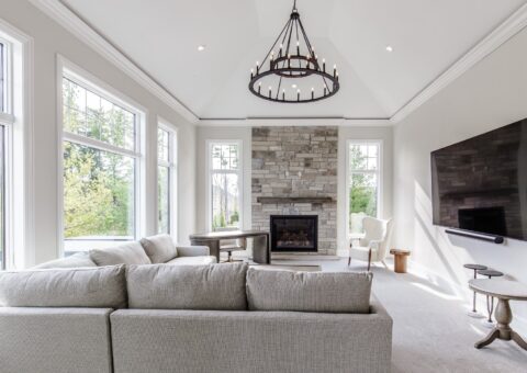 Settlers Circle hearth room with stone fireplace and iron chandelier