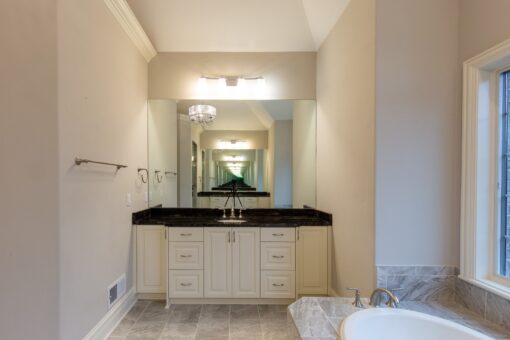 Woodview primary bath white vanity with black counter