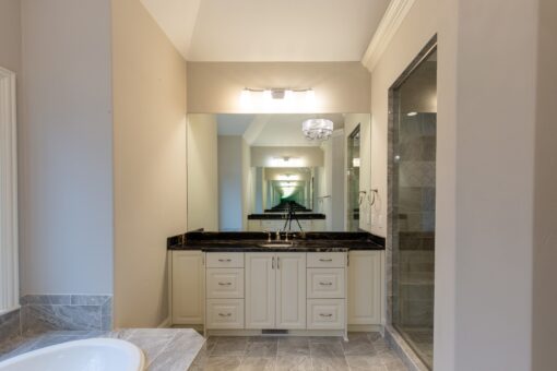 Woodview primary bath vanity and glass shower