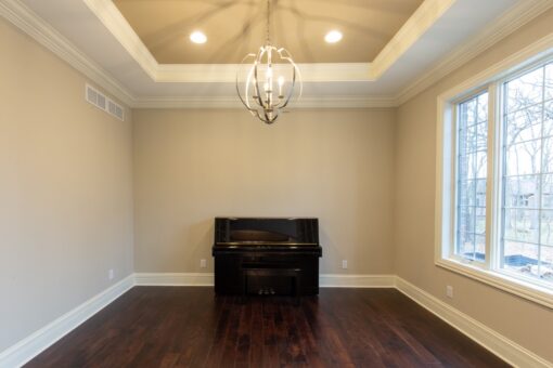 Woodview home office with tray ceiling and piano