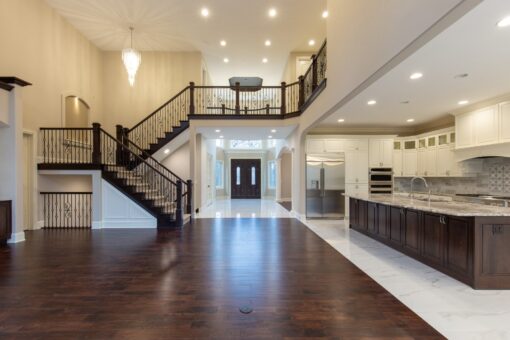 Woodview great room with staircase and view to the kitchen