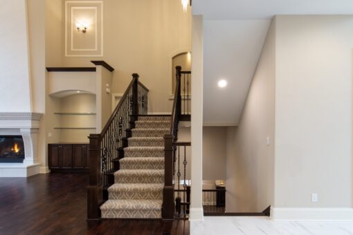 Woodview staircase with carpet runner and iron balusters
