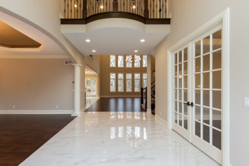 Woodview foyer with marble floor and balcony above