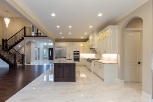 Woodview kitchen with dark island and view to the staircase