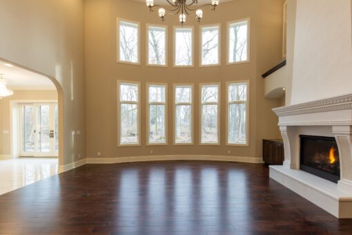 Woodview great room with two-story windows and fireplace
