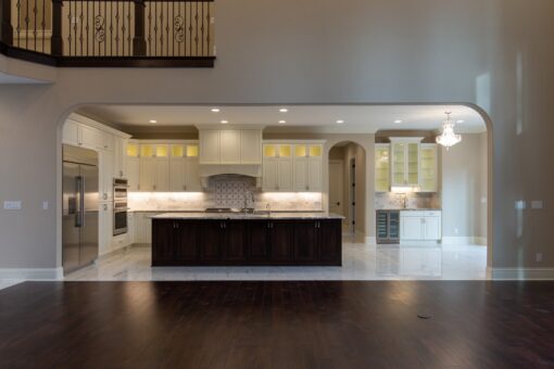 Woodview kitchen beneath the balcony with dark island