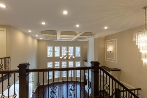 Woodview loft overlooking the great room with coffered ceiling